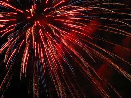 fireworks burst across the night sky with rockets red glare