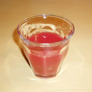 glass of sanguinello blood orange juice on a wooden table