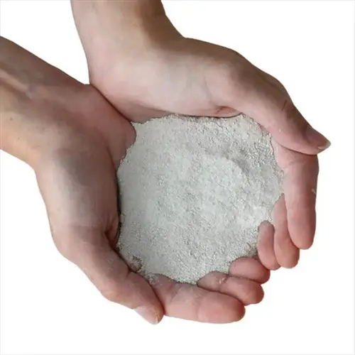 hands holding white potassium sulfate fertilizer powder