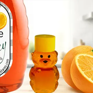 honey bear bottle beside sugar belle mandarin fruit and a jar