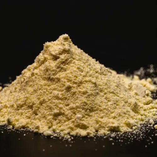pile of rock phosphate powder on a dark surface